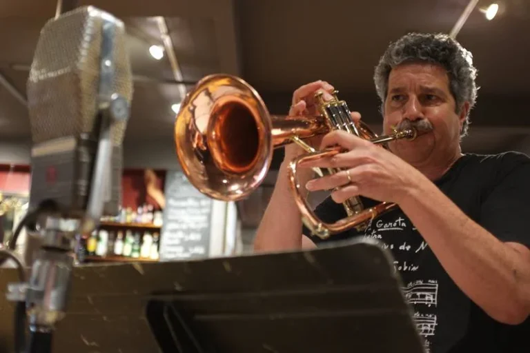 A photo of Mark Morganelli, Founder and Executive Director of Jazz Forum Arts, playing the flugelhorn